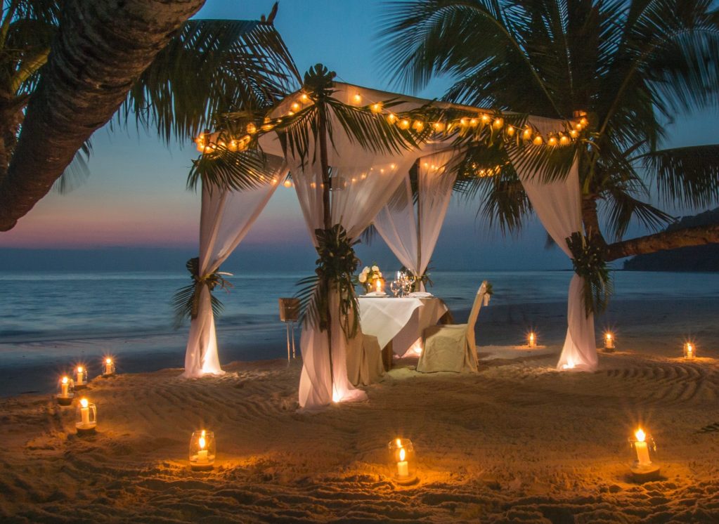 white canopy on Siesta Kaey Beach at night with candles